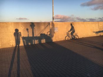 Shadow of man riding bicycle on street