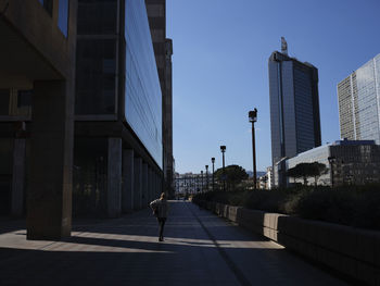 Street amidst buildings against sky in city
