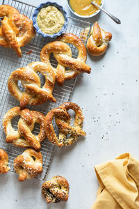 Top down view of baked pretzels on a cooling rack with copy space to the right.