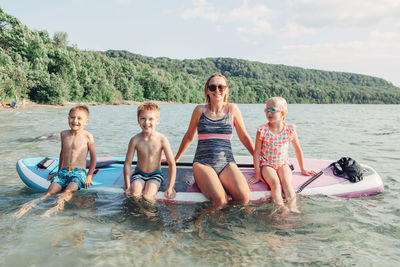 People enjoying in water at shore