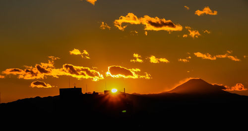 Scenic view of silhouette mountains against sky during sunset