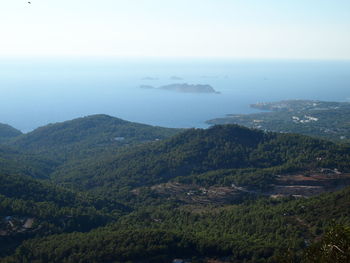 Scenic view of sea and mountains against sky