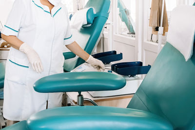 Midsection of doctor examining patient in hospital