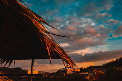 Low angle view of silhouette buildings against sky at sunset