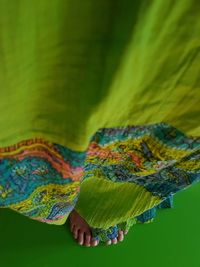 Close-up of woman on green background