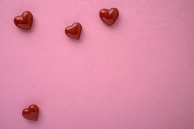 High angle view of heart shape on pink table