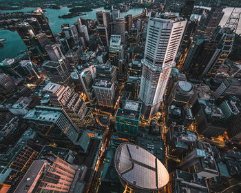 Aerial view of modern buildings in city at sunset