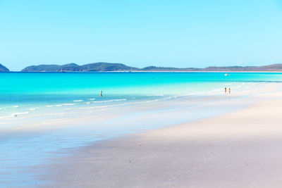 Scenic view of beach against blue sky