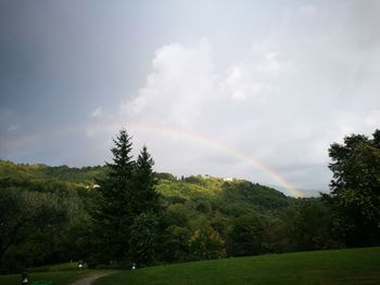 Scenic view of rainbow over landscape against sky