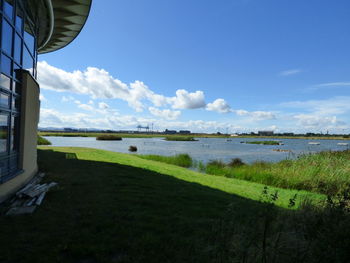 Scenic view of lake against cloudy sky