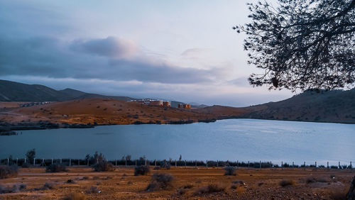 Scenic view of landscape and lake against sky