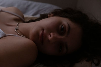 High angle view of young woman lying on bed at home