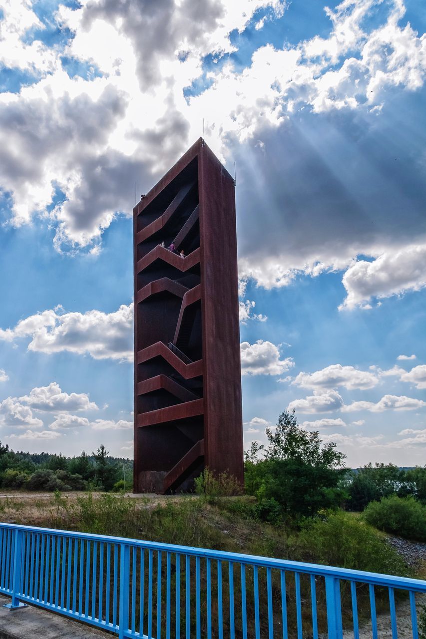 cloud - sky, sky, built structure, architecture, nature, building exterior, day, no people, plant, railing, tree, outdoors, building, blue, wood - material, low angle view, barrier, security, protection, boundary