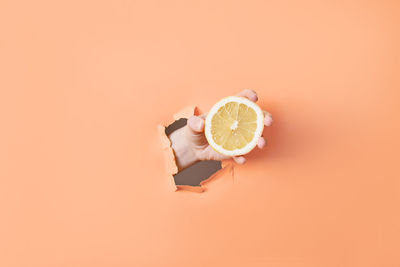 High angle view of navigational compass against yellow background