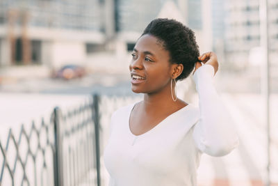 Portrait of smiling young woman standing outdoors