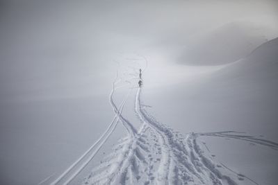 People walking on snow landscape