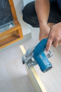 Hand held worm drive circular saw cutting boards at home. diy renovation makeover project.