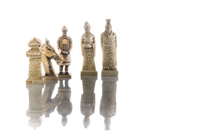 Low angle view of chess board against white background