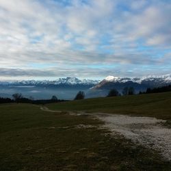 Scenic view of mountains against cloudy sky