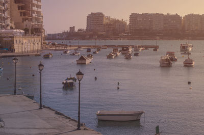 Boats in sea against clear sky
