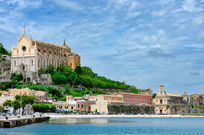 Gaeta seafront and historical churches against cloudy sky