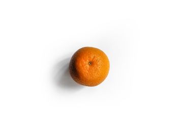 Close-up of orange apple against white background