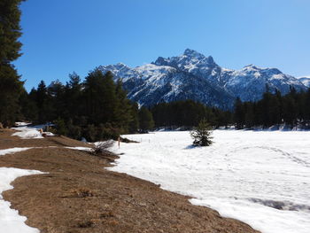 Scenic view of snowcapped mountains against clear sky