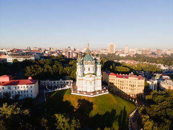 Buildings in city against clear sky