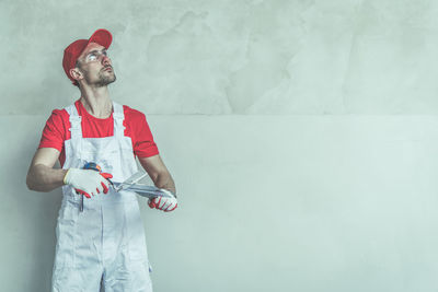 Full length of man standing against wall