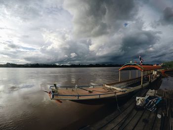 Boat moored on sea against sky