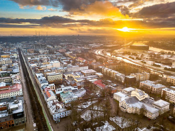 Aerial view of cityscape against sky during sunset