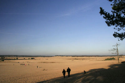 Full length of woman standing on dunes