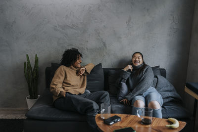 Multiracial male and female entrepreneurs laughing in break time at creative workplace