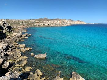 Scenic view of sea against clear blue sky