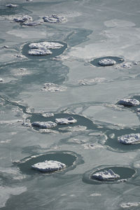 High angle view of frozen lake with pancake ice formations 