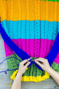 Midsection of woman with multi colored umbrella