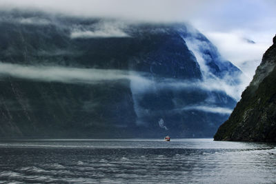 Tourist boat cruising in milford sound fjordland national park southland new zealand