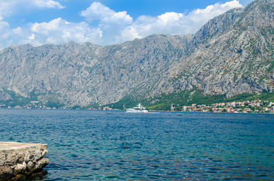 White yacht on a picturesque blue sea water in the bay of kotor