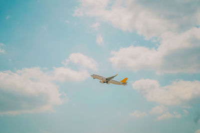 Low angle view of airplane flying in sky