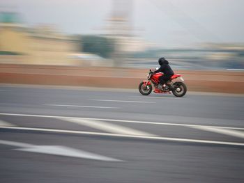 Person riding motorcycle on road