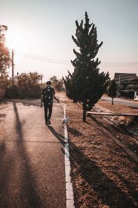 Man walking with frenchbulldog puppy