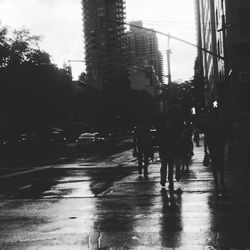 Silhouette of people walking on road