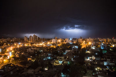 High angle view of illuminated buildings against sky at night