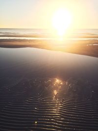 Close-up of sea against sky at sunset