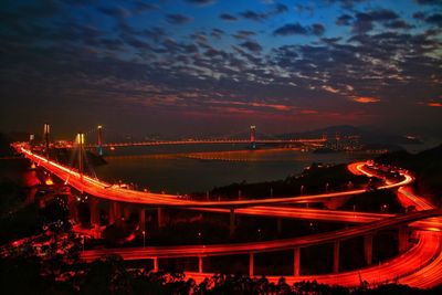 High angle view of illuminated city against sky at night