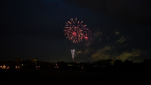 Low angle view of firework display at night