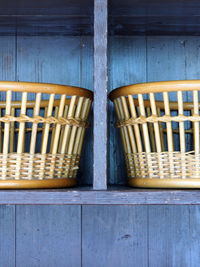 Wicker baskets on wooden shelf