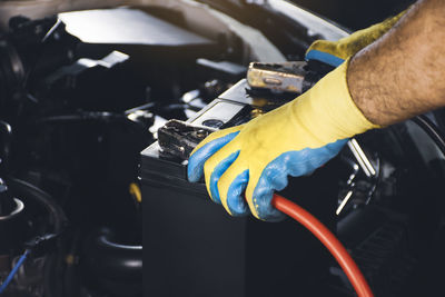 Close-up of man working in car