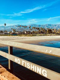 Scenic view of beach against blue sky