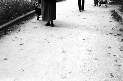 Low section of woman standing on tiled floor